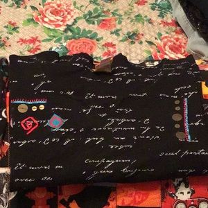 3/4 length sleeve top black  with multi color designs.